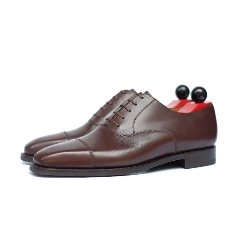 Men's Oxford shoes with a wingtip design and leather solePuget - Dark Oak Calf